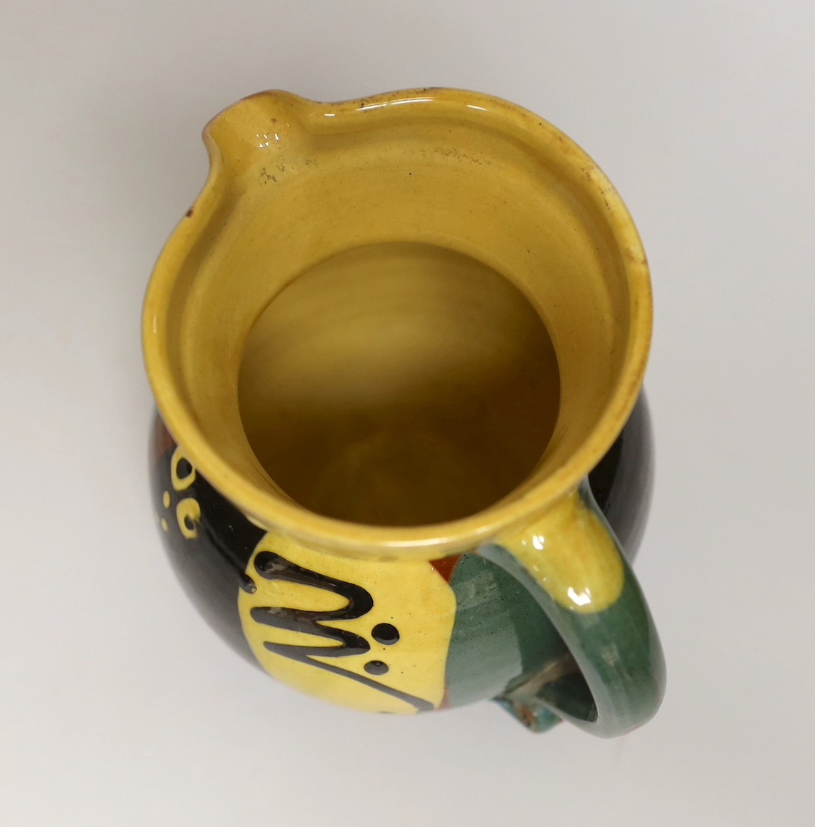 Margaret Brompton studio pottery bowl with insects, together with a slipware jug, a Longpark, Torquay small cockerel jug, and a Susan Juniper slipware jug, largest 21cm diameter, (4)